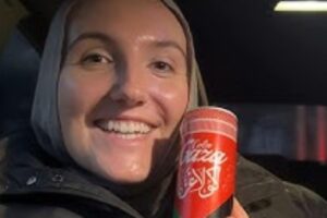 Una donna con una lattina di Gaza Cola
